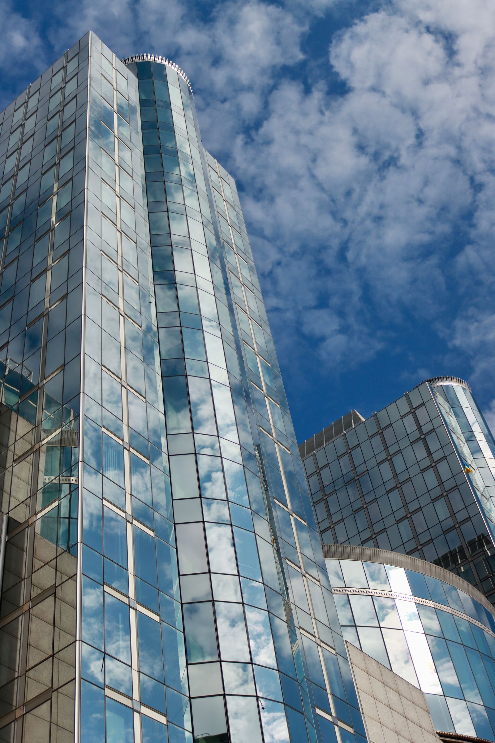 Low angle view of modern glass skyscrapers with curtain wall facade
