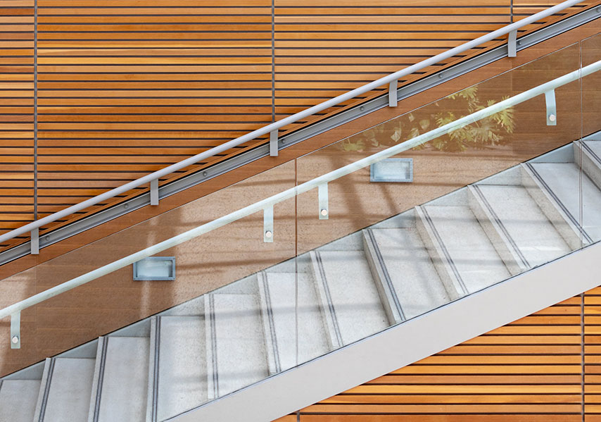 Glass and steel handrail installation on staircase