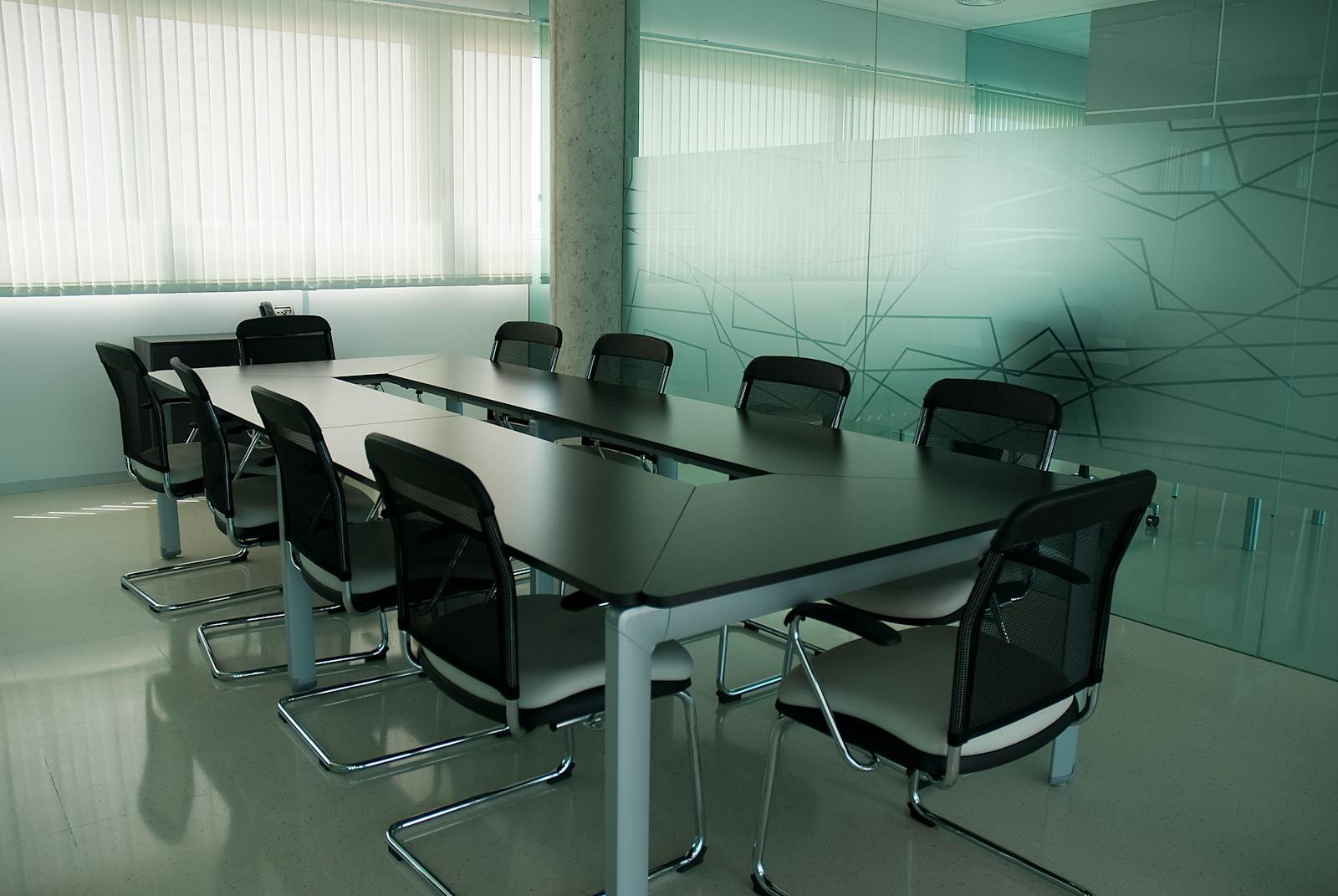 Elegant conference room with sleek black chairs and glass wall