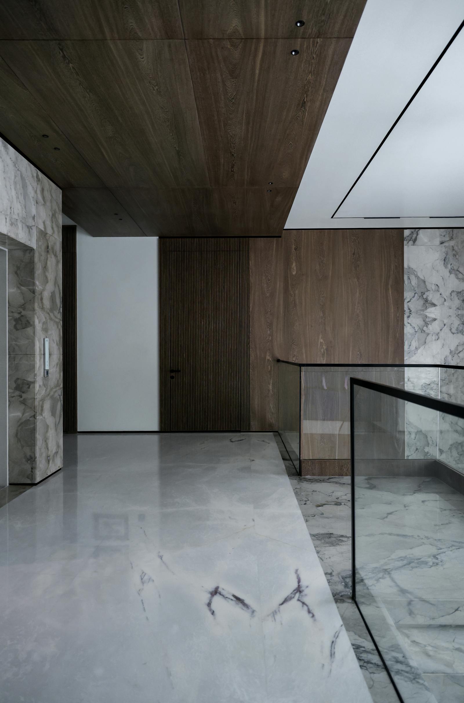 Luxurious modern interior featuring marble floors and rich wood paneling